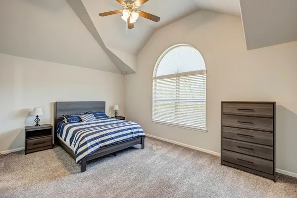 a kitchen with stainless steel appliances granite countertop a table chairs and a refrigerator