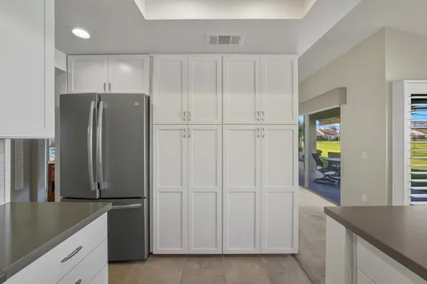 a view of a kitchen with cabinets and stainless steel appliances