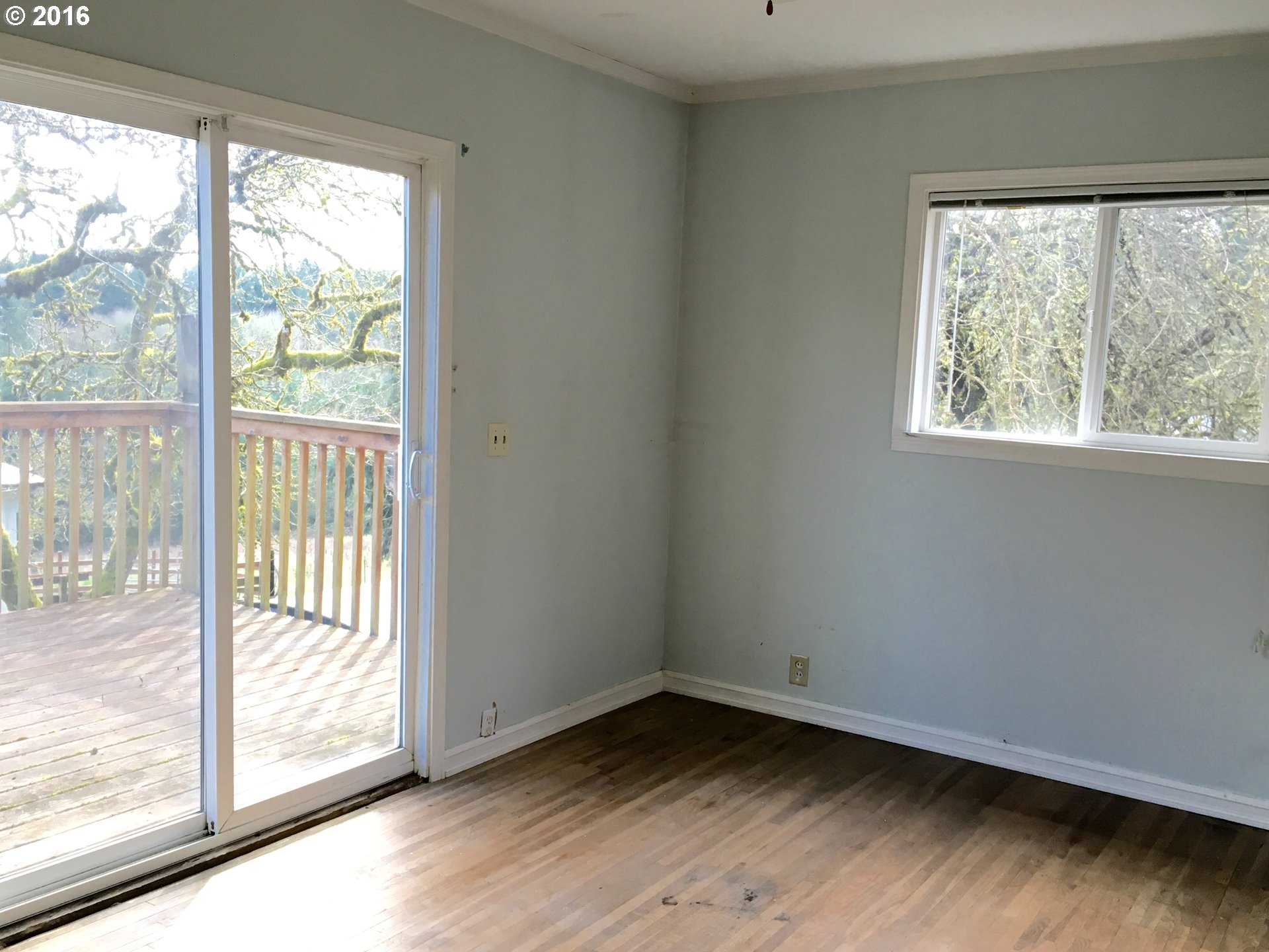 17640 Southwest Neugebauer Road Hillsboro, OR 97123 - Photo 6 of 30 a view of an empty room and wooden floor and a window