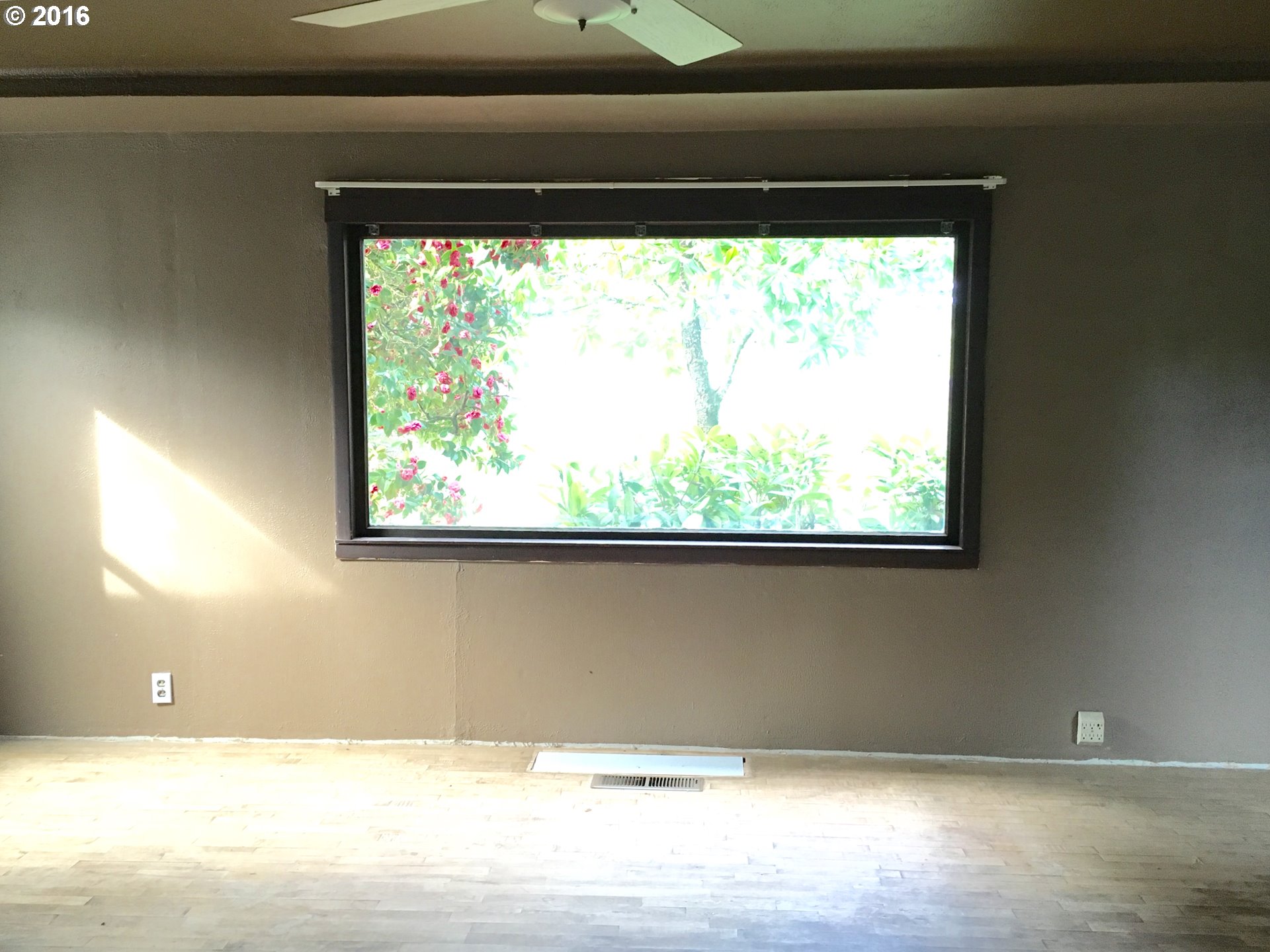 17640 Southwest Neugebauer Road Hillsboro, OR 97123 - Photo 8 of 30 a view of a room with a window and a ceiling fan