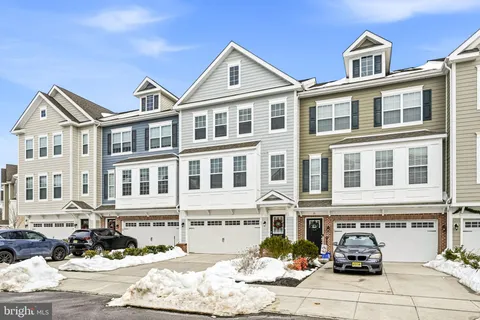a front view of a residential apartment building with parking space