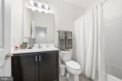 a bedroom with bed chair and window