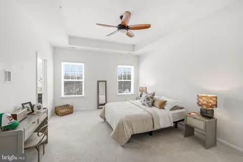 a bedroom with a bed and ceiling fan