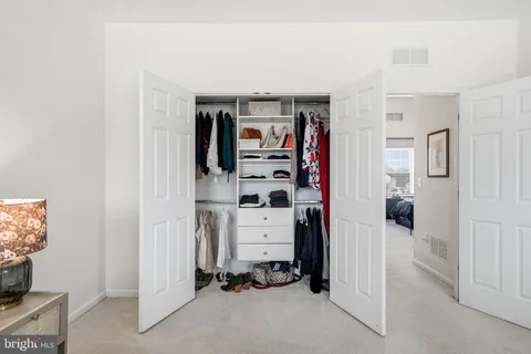 a bathroom with a granite countertop sink double mirror and a bathtub