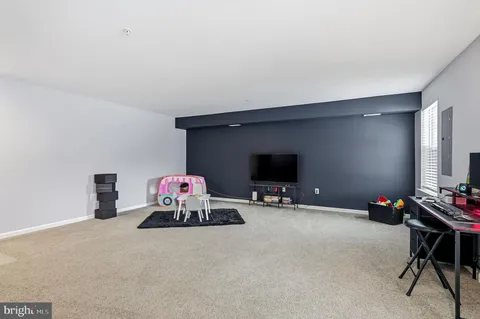 a bedroom with furniture and a flat screen tv