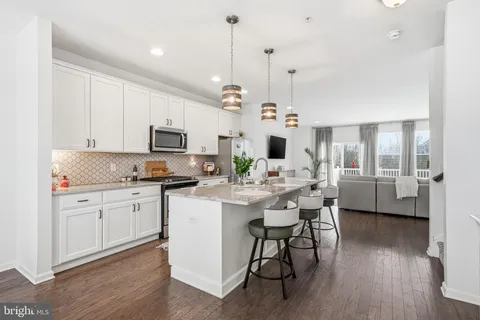 a kitchen with sink cabinets and wooden floor