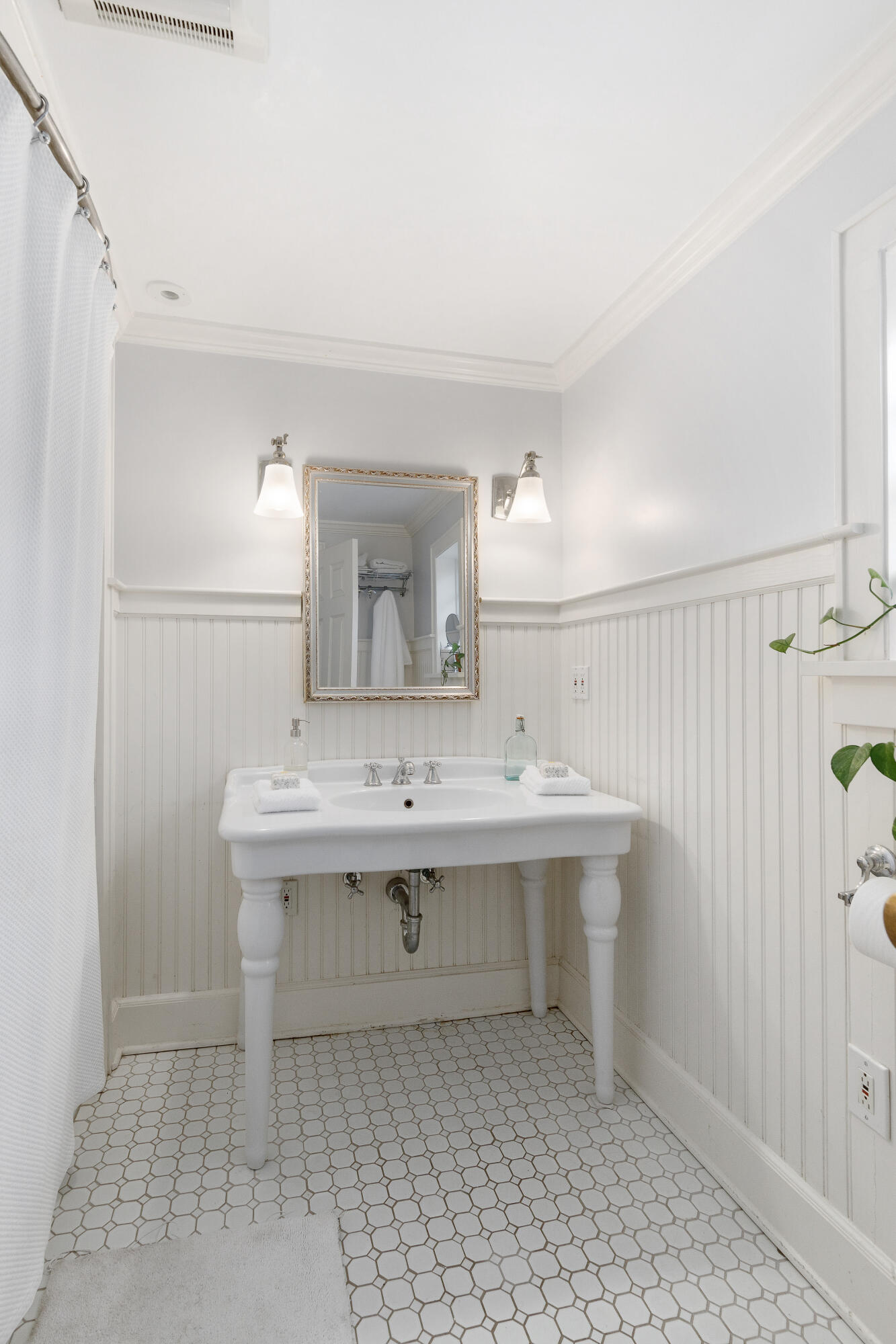 121 Middlesex Road Darien, CT 06820 - Photo 26 of 34 a view of a bathroom with a sink and mirror