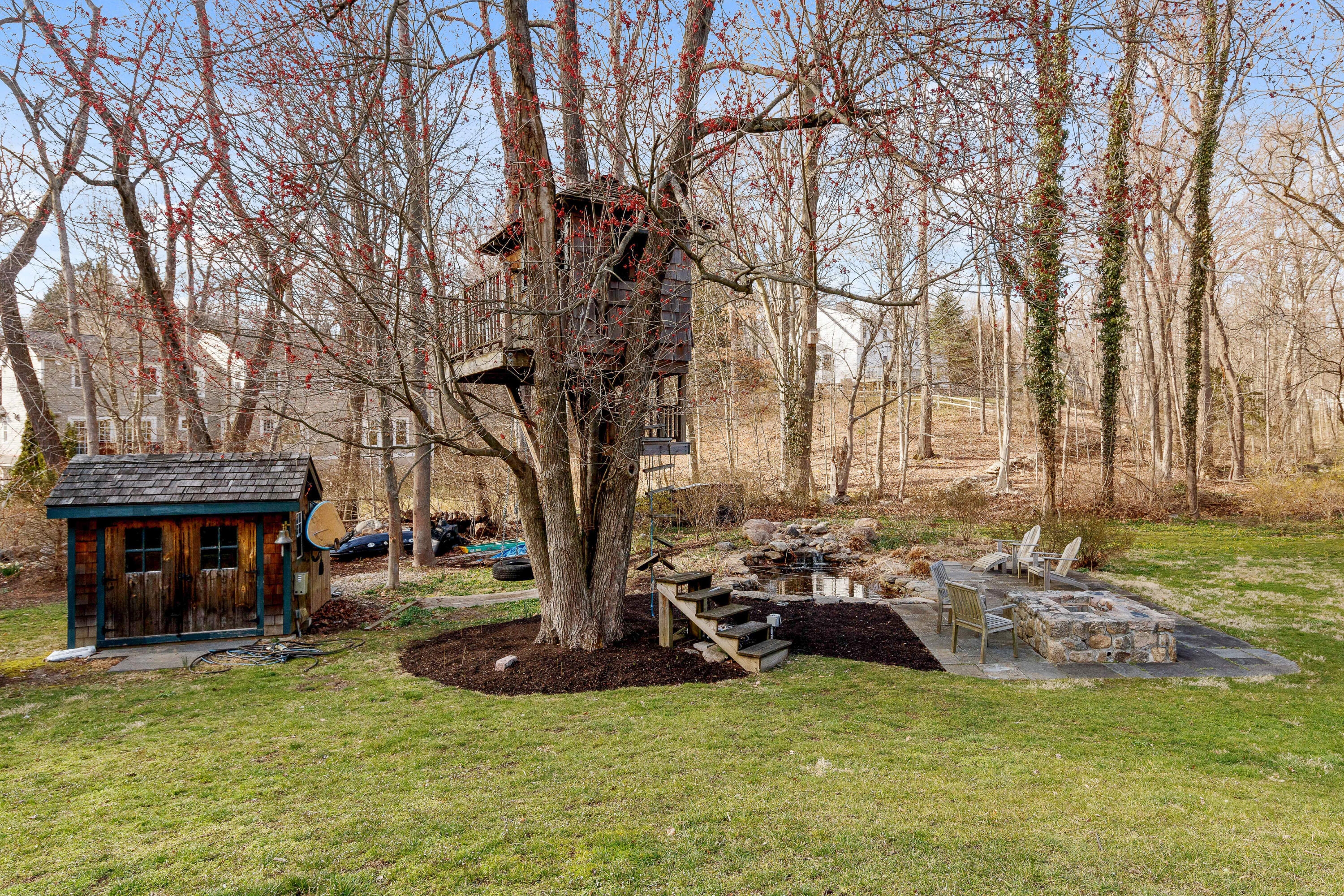121 Middlesex Road Darien, CT 06820 - Photo 31 of 34 a view of a swimming pool with a table and chairs under an umbrella