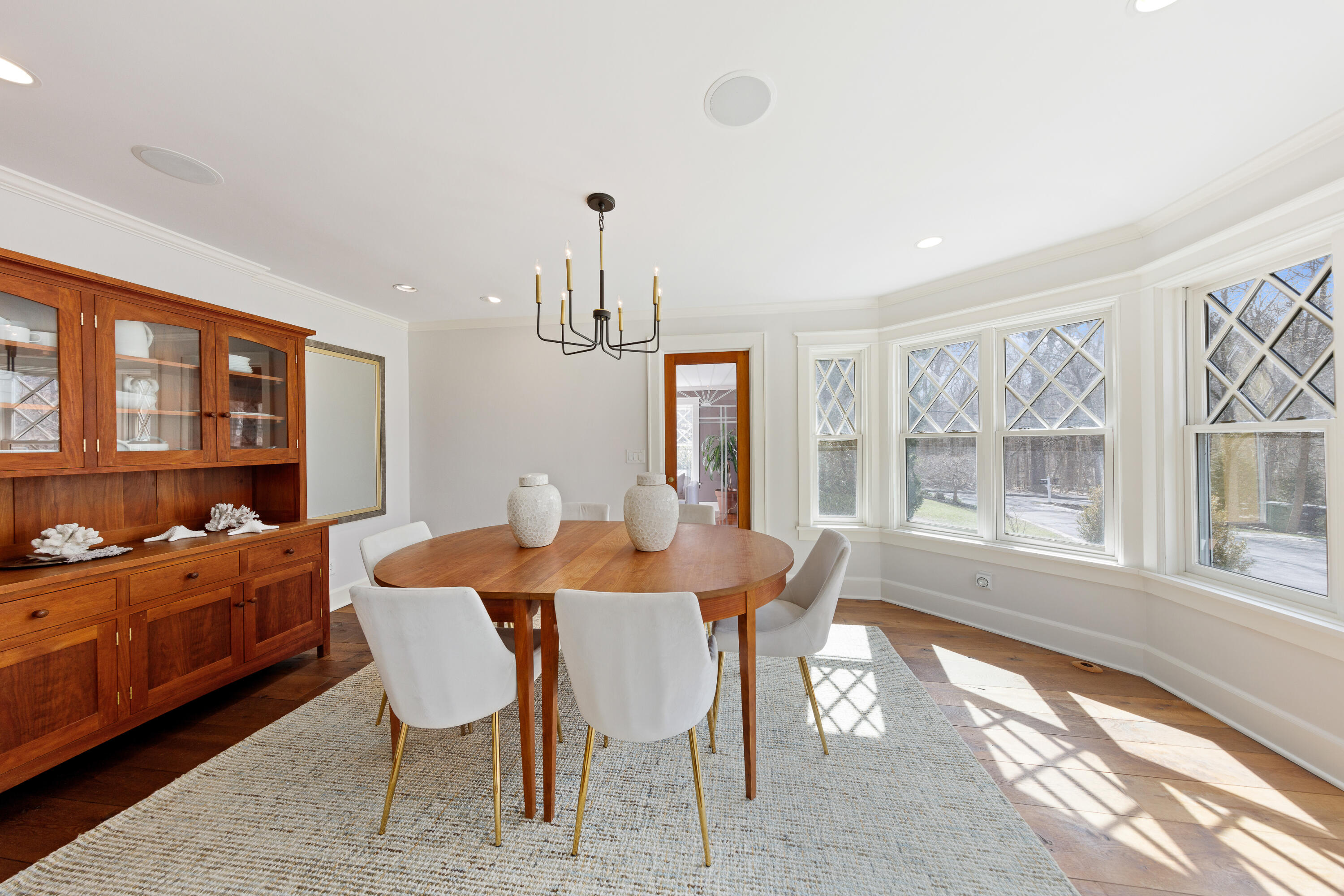 121 Middlesex Road Darien, CT 06820 - Photo 10 of 34 a view of a dining room with furniture large windows and wooden floor