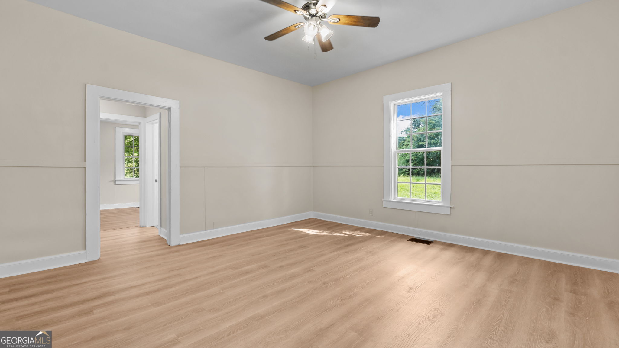 335 South McLin Street Rome, GA 30161 - Photo 3 of 21 wooden floor in an empty room with a window