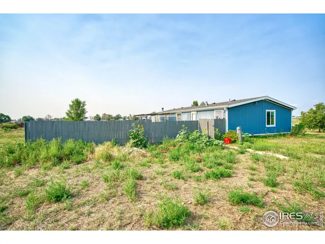 a backyard of a house with wooden fence
