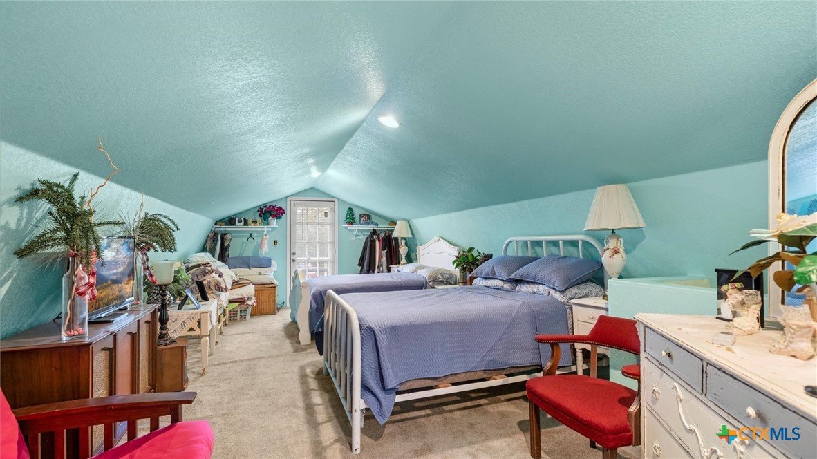 857 Derrick Drive Spring Branch, TX 78070 - Photo 17 of 32 a bedroom with furniture and a flat screen tv