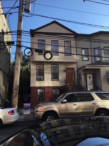 a front view of a house with parking space