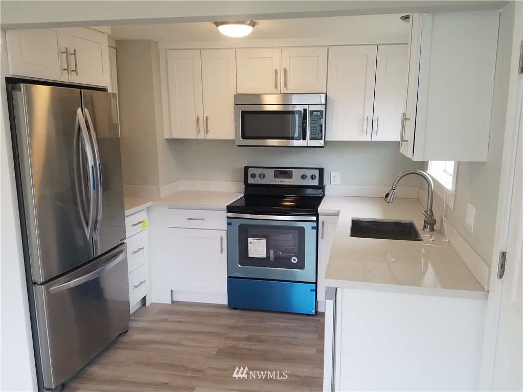 58 Shattuck Avenue South Renton, WA 98057 - Photo 4 of 13 a kitchen with a refrigerator sink and microwave