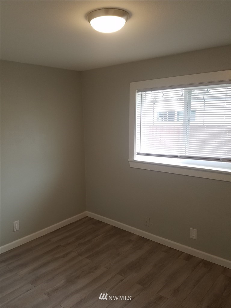 58 Shattuck Avenue South Renton, WA 98057 - Photo 8 of 13 an empty room with wooden floor and windows