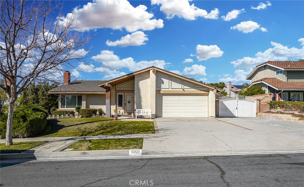 a view of a white house with a yard and plants