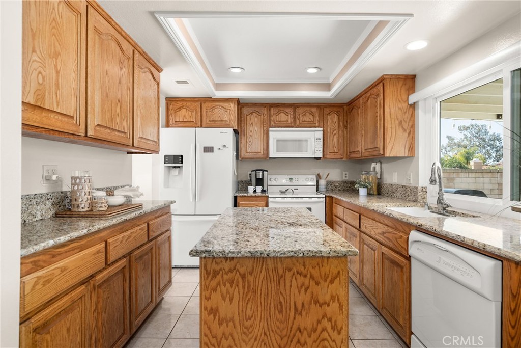 1869 Sugarloaf Avenue Upland, CA 91784 - Photo 11 of 41 a kitchen with stainless steel appliances granite countertop a stove a sink dishwasher and a refrigerator