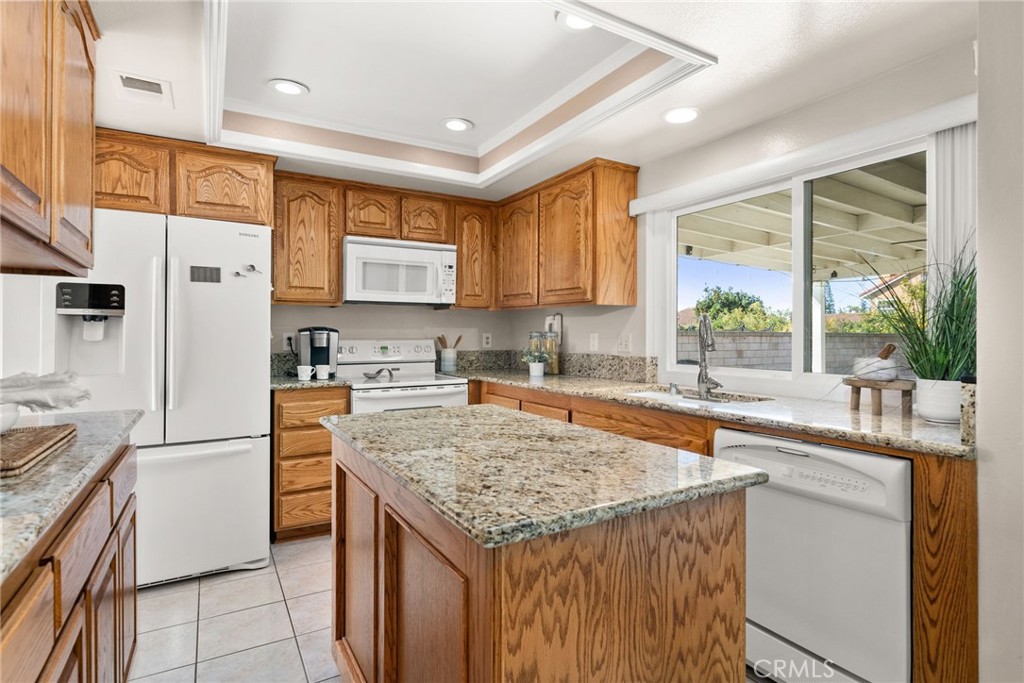 1869 Sugarloaf Avenue Upland, CA 91784 - Photo 12 of 41 a kitchen with granite countertop a sink stove and refrigerator