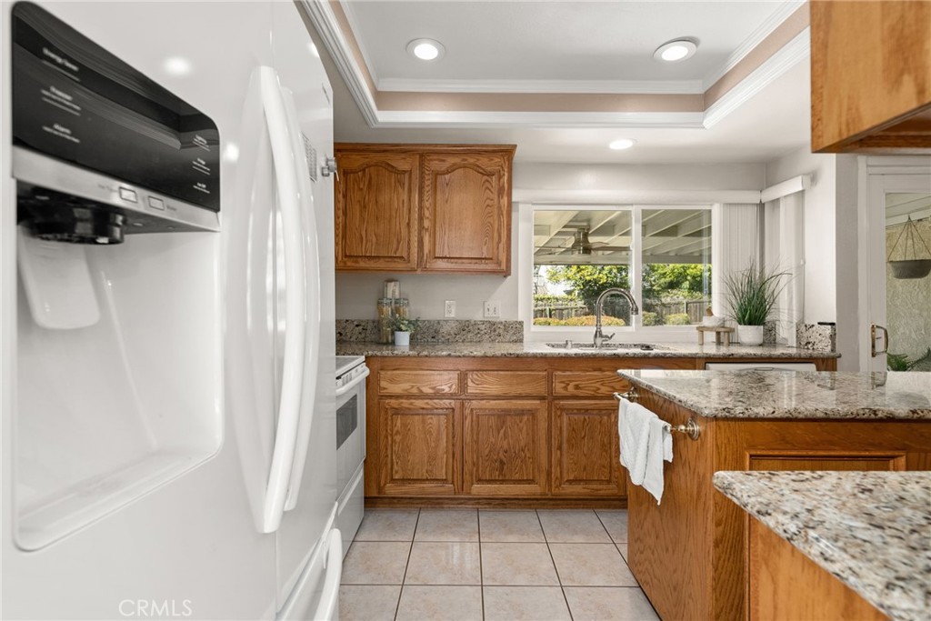 1869 Sugarloaf Avenue Upland, CA 91784 - Photo 14 of 41 a kitchen with stainless steel appliances granite countertop a sink a stove and a refrigerator