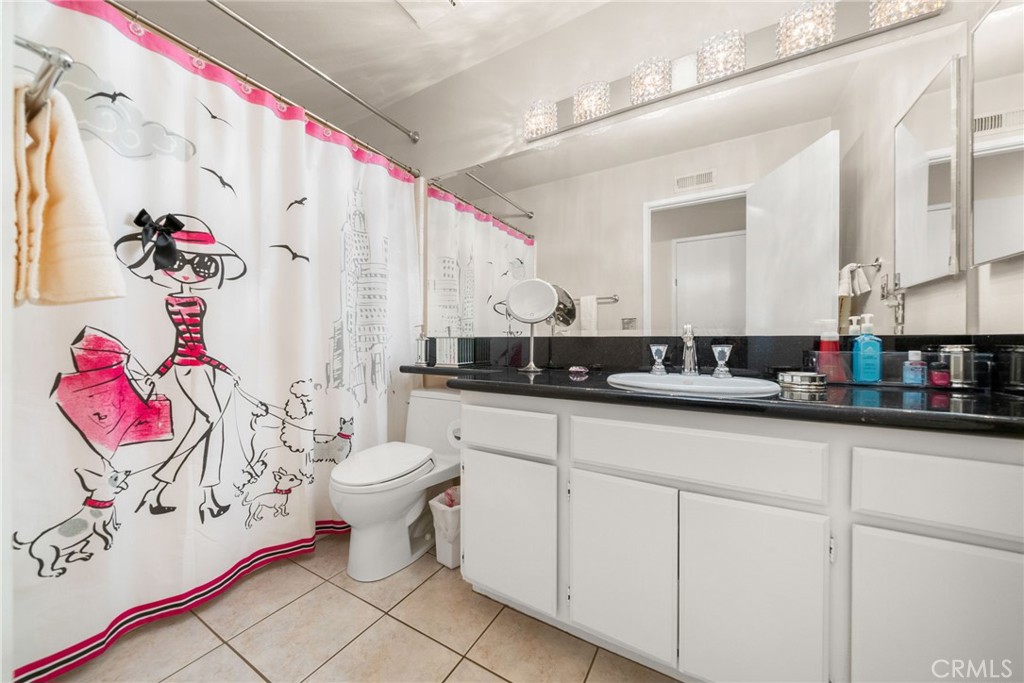 1869 Sugarloaf Avenue Upland, CA 91784 - Photo 21 of 41 a bathroom with a sink mirror and vanity