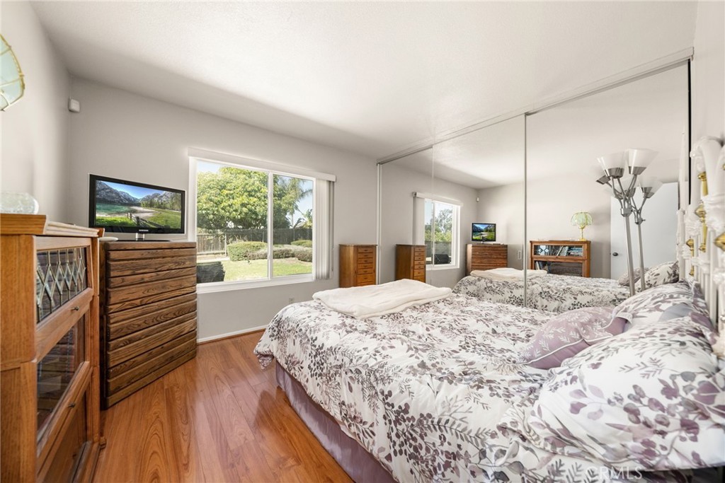 1869 Sugarloaf Avenue Upland, CA 91784 - Photo 23 of 41 a bedroom with a large bed and a flat tv screen