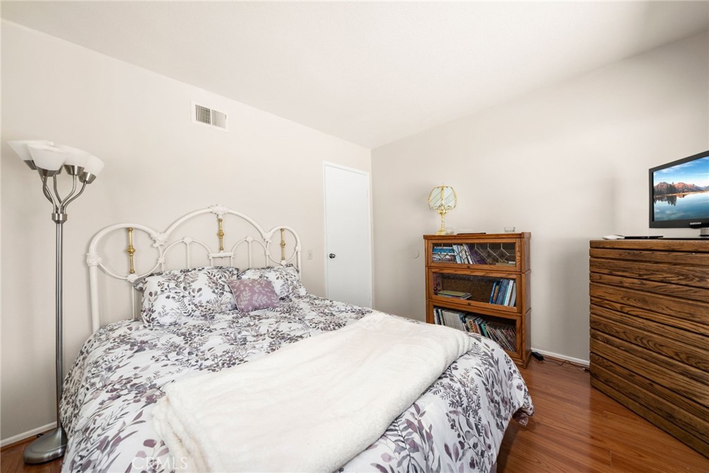 1869 Sugarloaf Avenue Upland, CA 91784 - Photo 24 of 41 a bedroom with a bed and a potted plant on the dresser