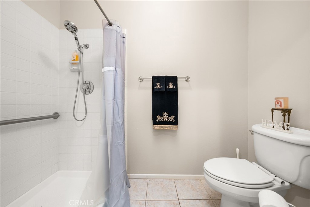1869 Sugarloaf Avenue Upland, CA 91784 - Photo 25 of 41 a bathroom with a toilet and a shower