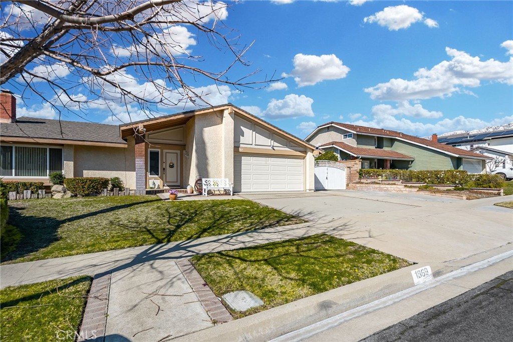 1869 Sugarloaf Avenue Upland, CA 91784 - Photo 3 of 41 a front view of a house with garden