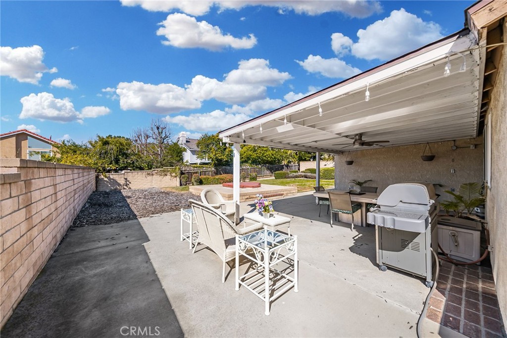 1869 Sugarloaf Avenue Upland, CA 91784 - Photo 32 of 41 a view of a patio with dining table and chairs with wooden floor