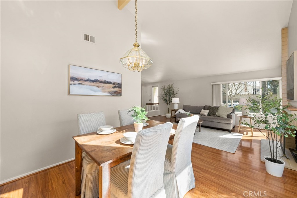 1869 Sugarloaf Avenue Upland, CA 91784 - Photo 10 of 41 a view of a dining room with furniture a chandelier and wooden floor