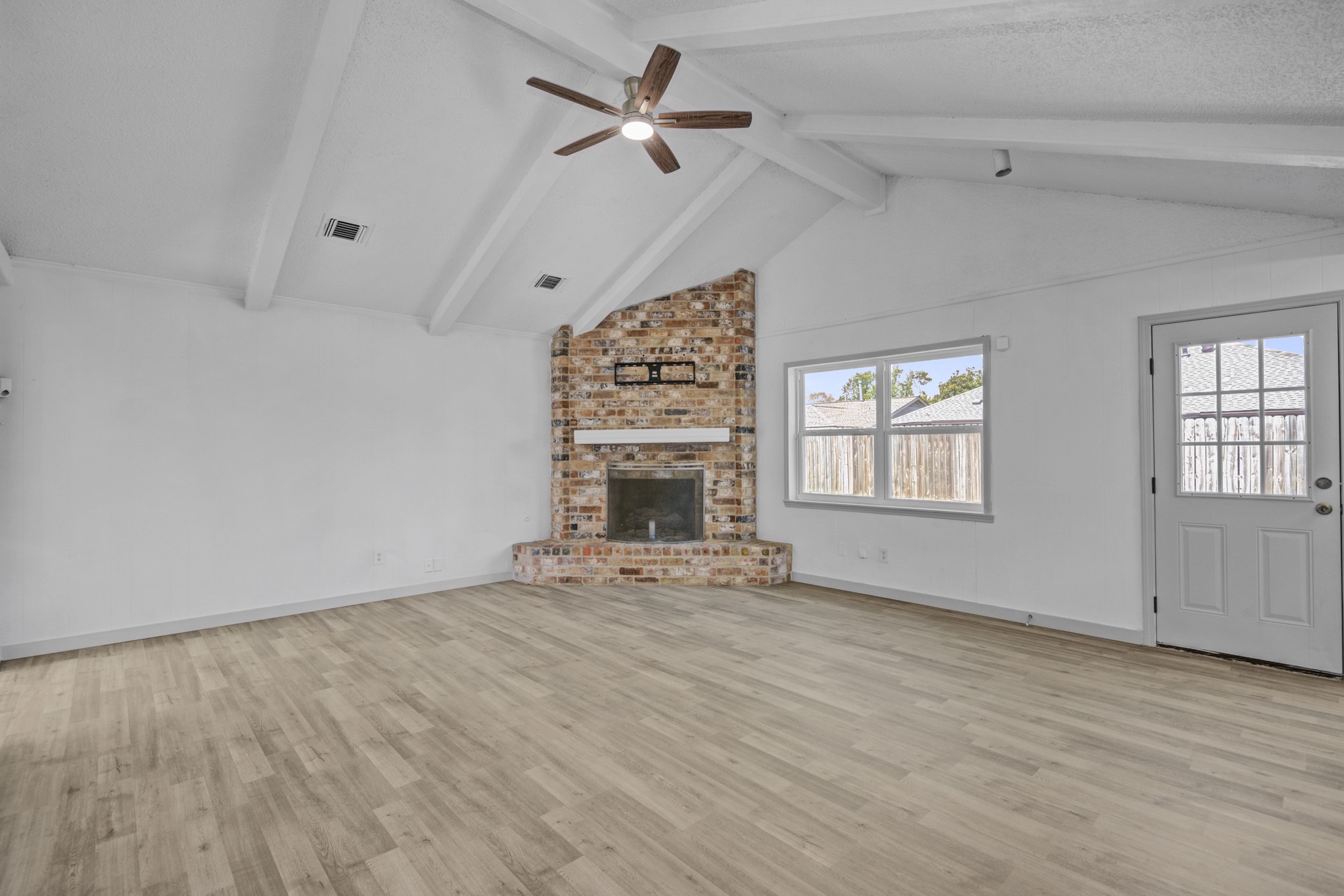 13747 Rampchester Lane Houston, TX 77015 - Photo 11 of 24 an empty room with windows and fireplace
