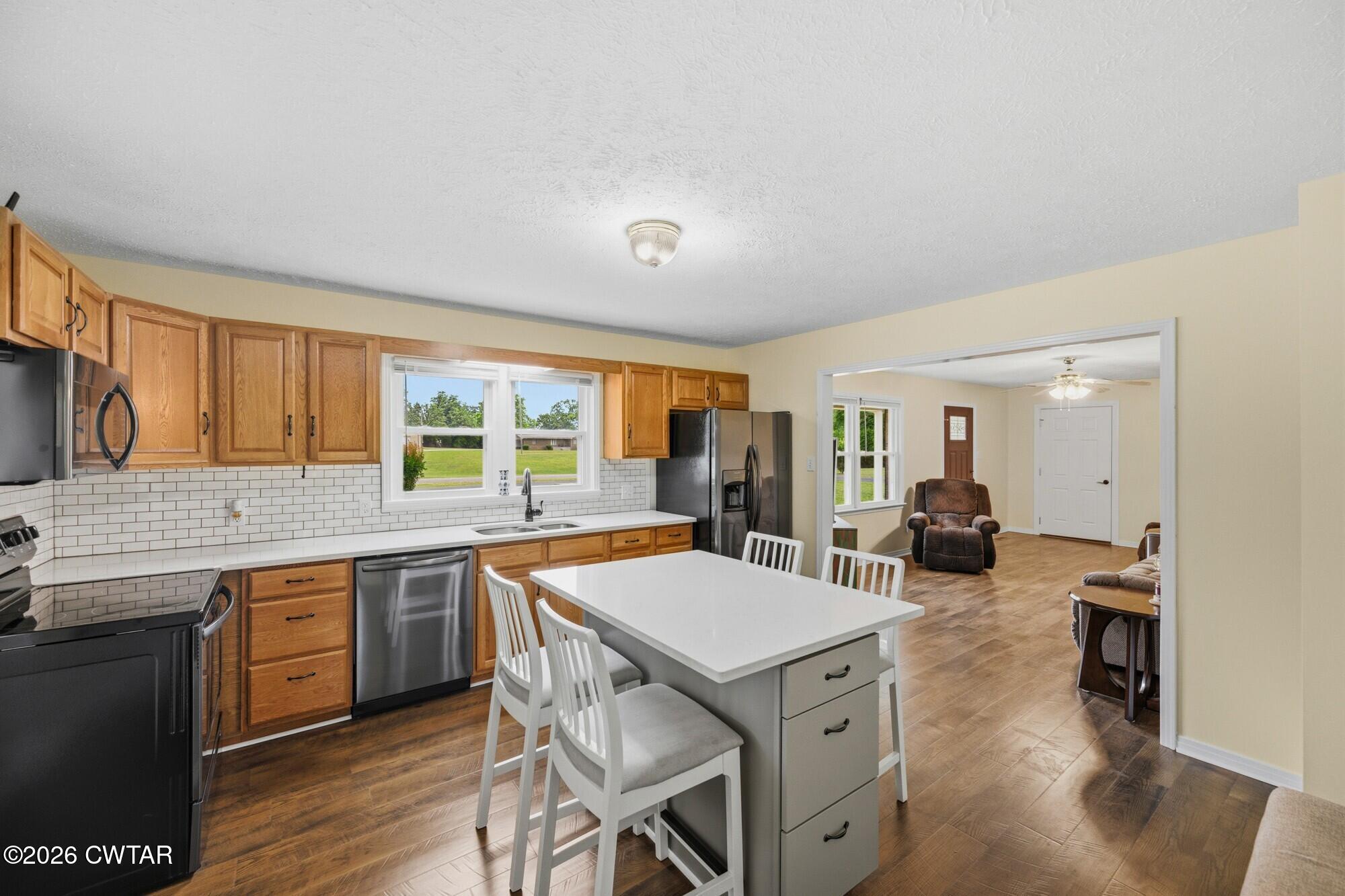 944 Brooksie Thompson Road Decaturville, TN 38329 - Photo 10 of 47 a large kitchen with a table and chairs in it