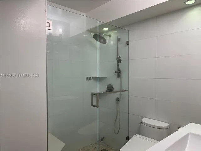 a bathroom with a toilet and shower