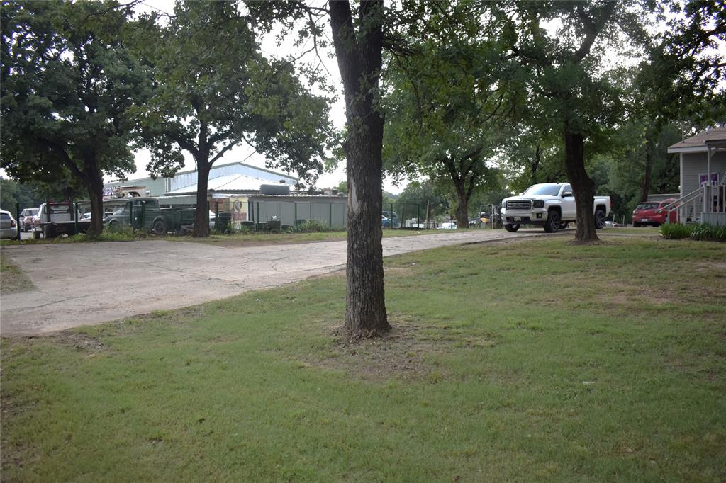 4550 Dick Price Road Fort Worth, TX 76140 - Photo 11 of 21 a white house that has a tree in front of it