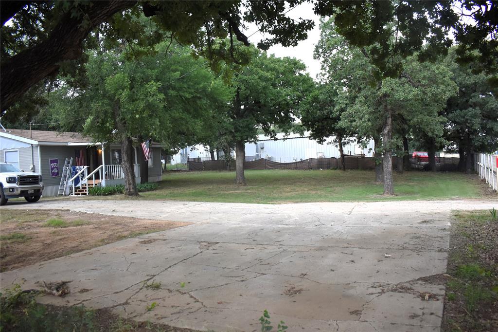 4550 Dick Price Road Fort Worth, TX 76140 - Photo 12 of 21 a view of a yard with a tree
