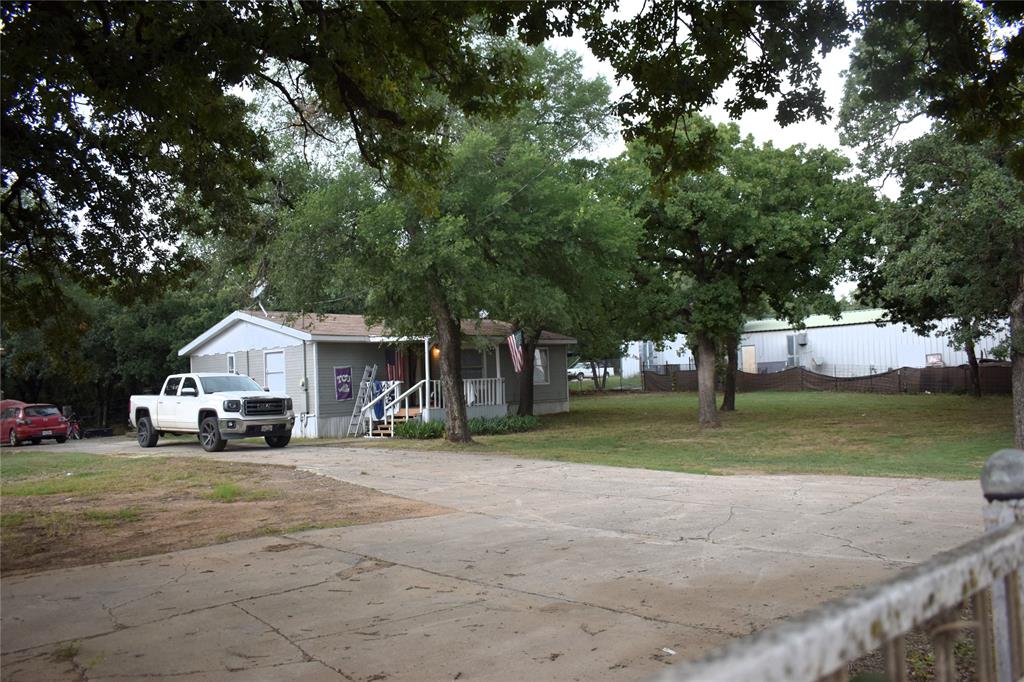 4550 Dick Price Road Fort Worth, TX 76140 - Photo 13 of 21 a view of a house with a big yard and large trees