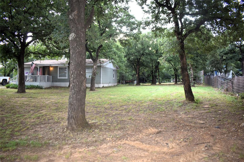 4550 Dick Price Road Fort Worth, TX 76140 - Photo 17 of 21 a view of a house with backyard and tree
