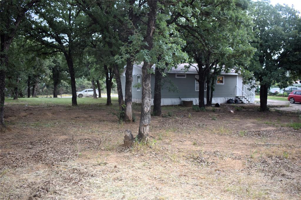 4550 Dick Price Road Fort Worth, TX 76140 - Photo 20 of 21 a backyard of a house with lots of green space
