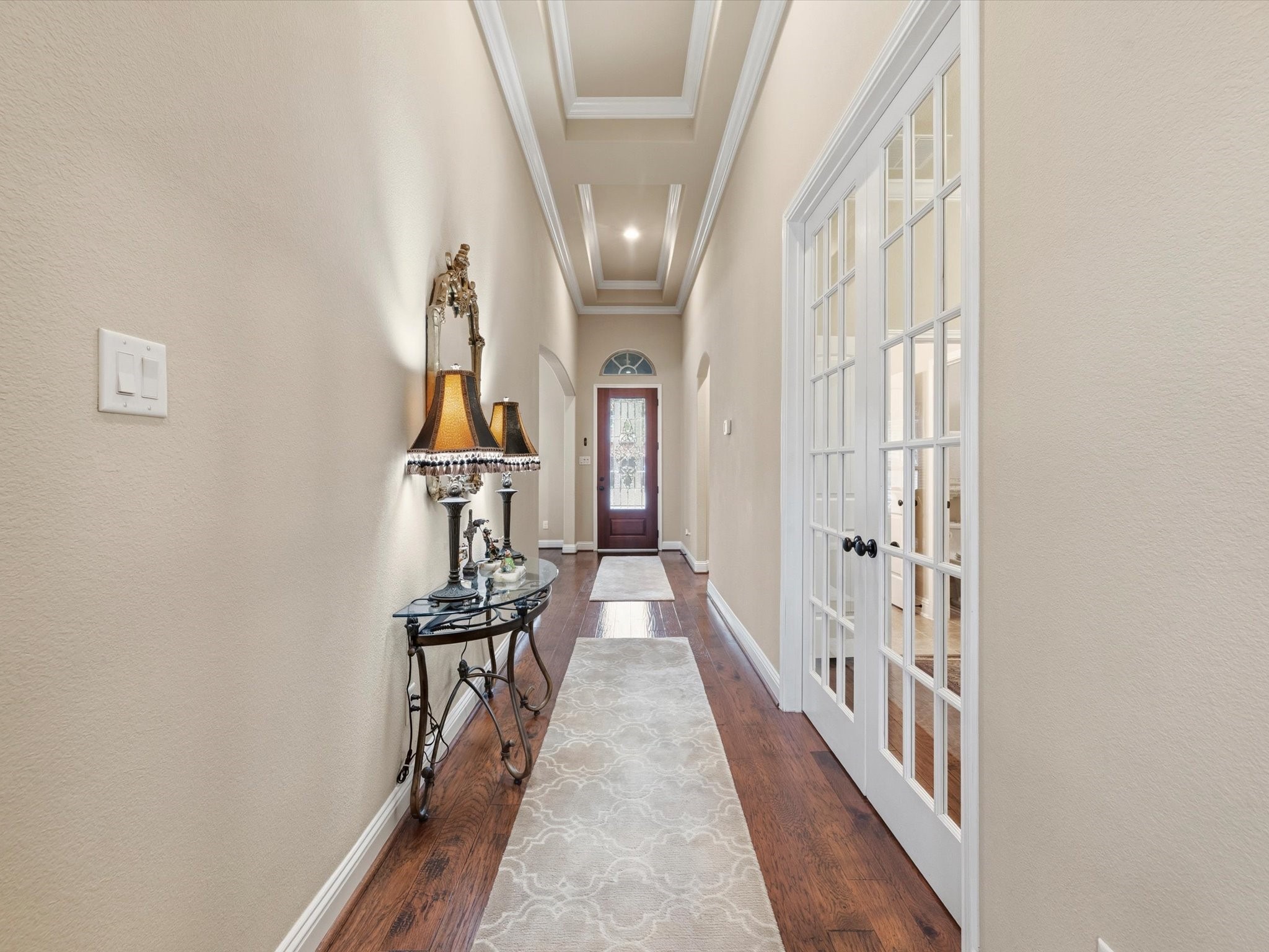 3907 Randle Ridge Court Fulshear, TX 77441 - Photo 4 of 46 Extended entryway with elegant wood flooring and soft beige walls. The area is well-lit with recessed lighting and features French doors on the right to access the home office.