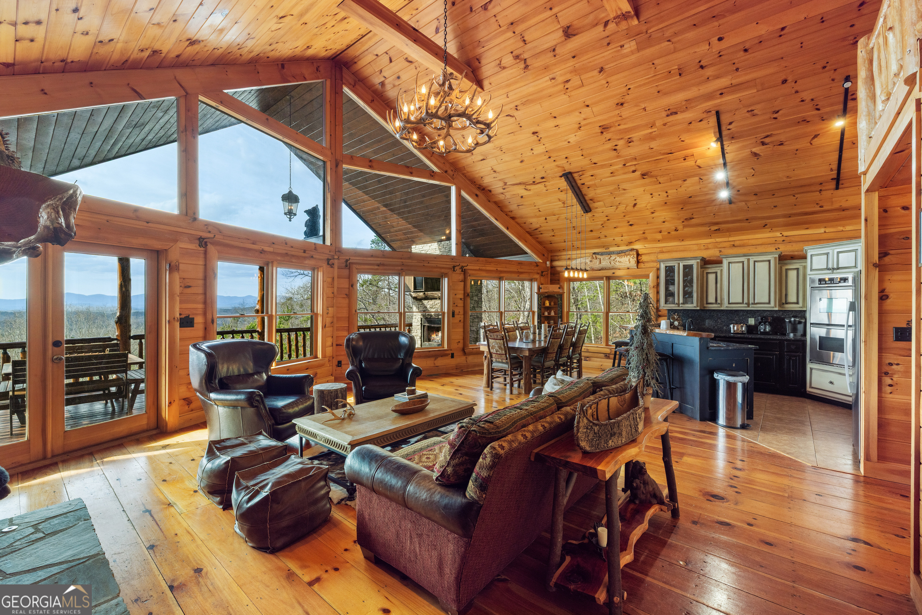 180 Cinnamon Bear Road Mineral Bluff, GA 30559 - Photo 2 of 49 a living room with furniture a wooden floor and next to a large window