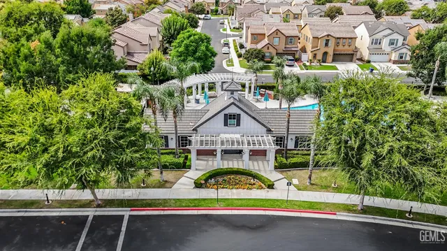 an aerial view of a house with a yard and potted plants