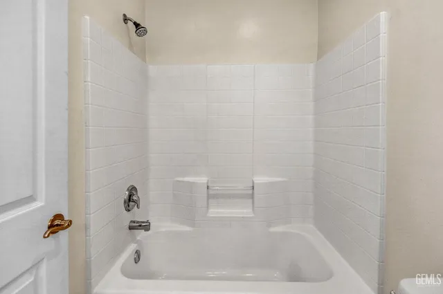 a bath tub sitting next to a white sink