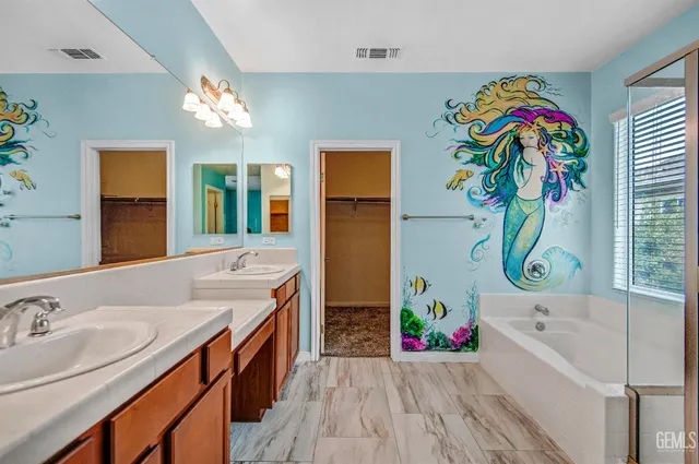 a bathroom with a sink a vanity and a bathtub