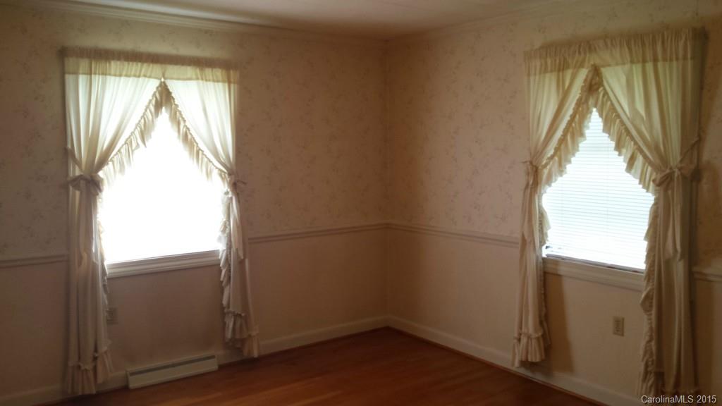 87 Lee Road Stony Point, NC 28678 - Photo 22 of 24 an empty room with wooden floor and windows