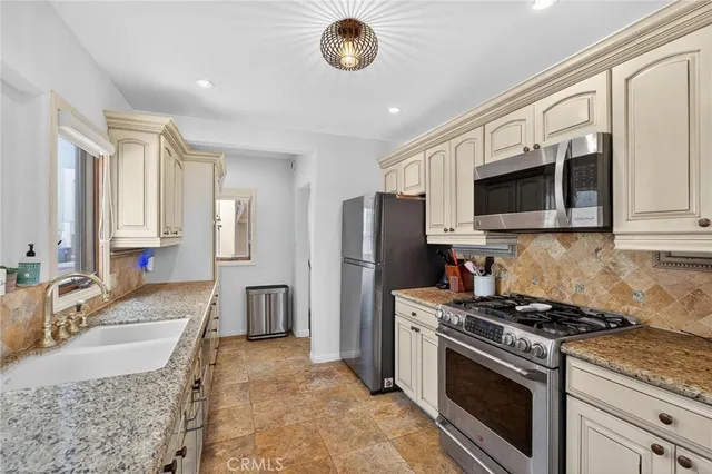 a kitchen with a sink stove and cabinets
