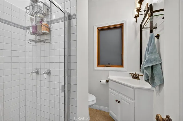 a bathroom with a sink and mirror with toilet