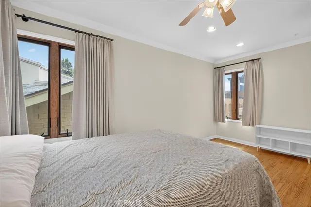 a spacious bedroom with a bed and a chandelier