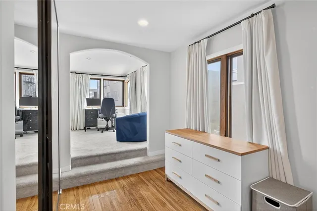 a bathroom with a granite countertop double vanity and a mirror