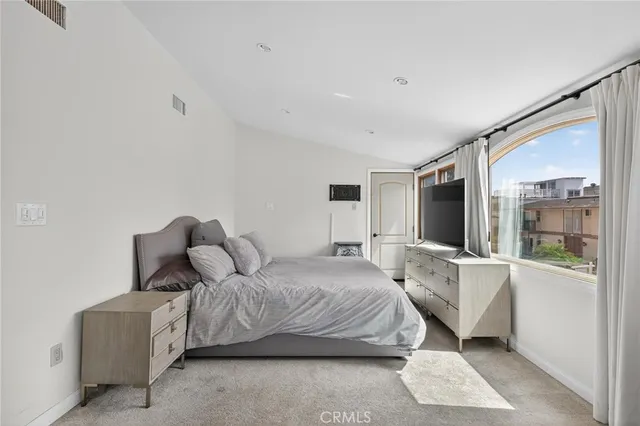 a bedroom with furniture and a flat screen tv