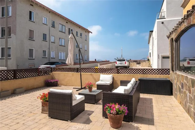 a view of a patio with couches and potted plants